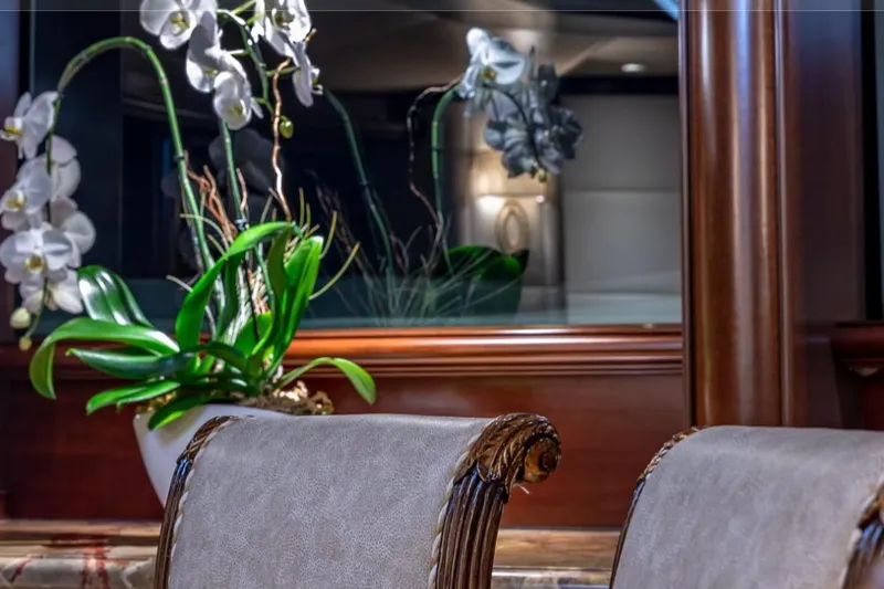 Slide: The Image of Elegant yacht interior with orchids and ornate chairs, Van Mill 143 Tri-Deck Motor Yacht, 1988. - 62