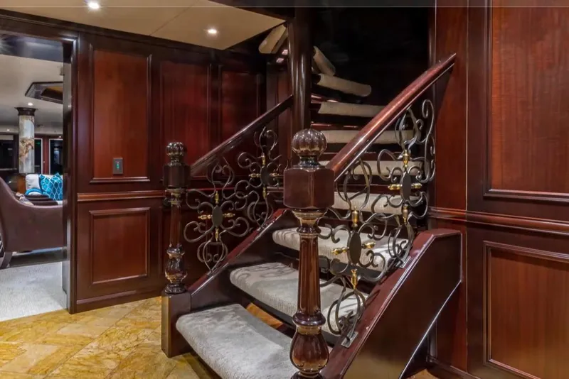 Slide: The Image of Luxurious wooden staircase with ornate railing on Van Mill 143 Tri-Deck Motor Yacht, 1988. - 68