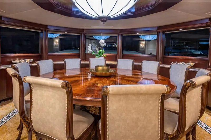Slide: The Image of Luxurious dining area on 1988 Van Mill 143 Tri-Deck Motor Yacht with elegant wood table. - 70