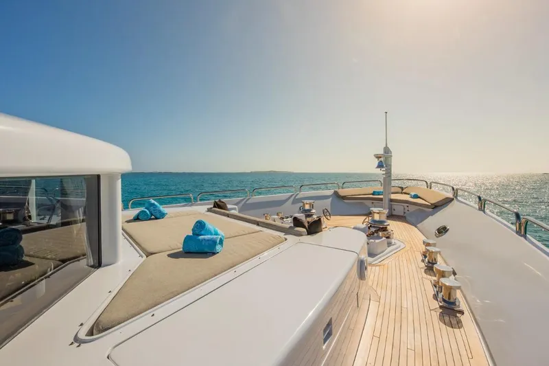 Slide: The Image of Luxurious Van Mill 143 Tri-Deck Motor Yacht deck with sun loungers and ocean view. - 8