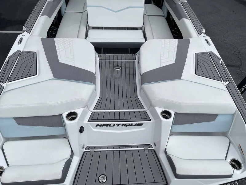 Slide: The Image of 2022 Nautique G25 boat rear with gray and white upholstery. - 13