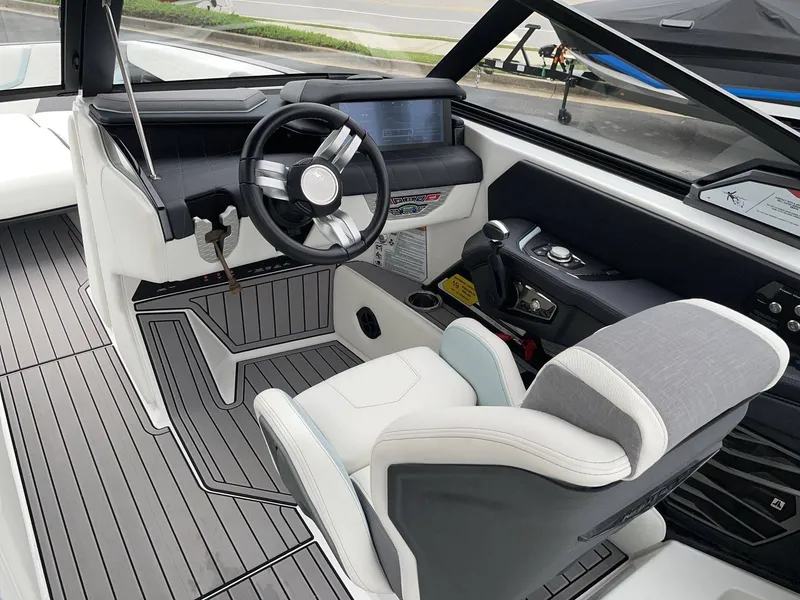 Slide: The Image of Interior of a 2022 Nautique G25 boat with modern helm. - 14