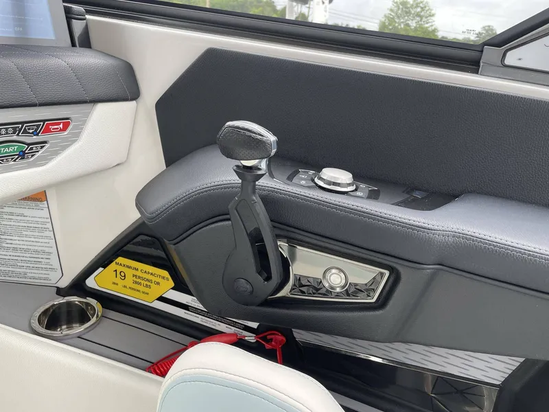 Slide: The Image of Interior of 2022 Nautique G25 with throttle lever and controls. - 15