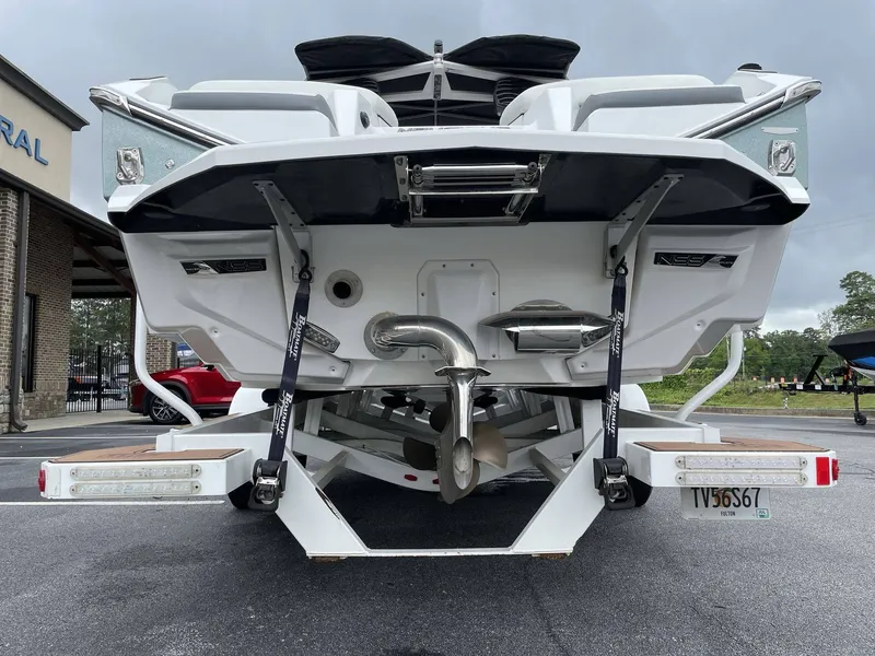 Slide: The Image of Rear view of a 2022 Nautique G25 boat on a trailer. - 16