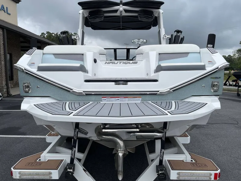 Slide: The Image of Rear view of a 2022 Nautique G25 boat on a trailer. - 17
