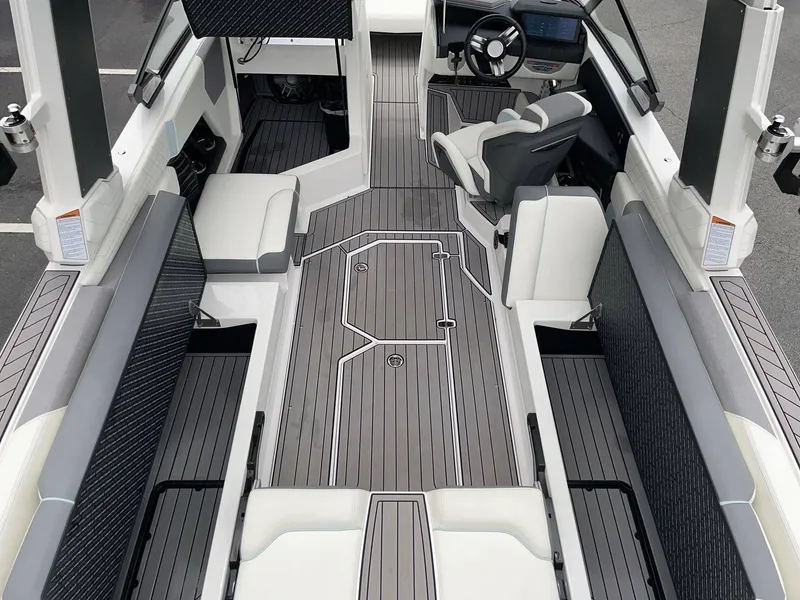 Slide: The Image of Interior of 2022 Nautique G25 with modern seating and helm console. - 20