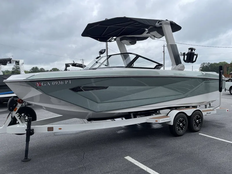 Slide: The Image of 2022 Nautique G25 boat on trailer, gray color, side view. - 22