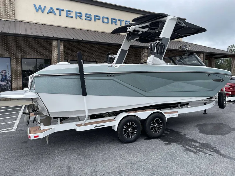 Slide: The Image of 2022 Nautique G25 boat parked outside watersports store. - 25