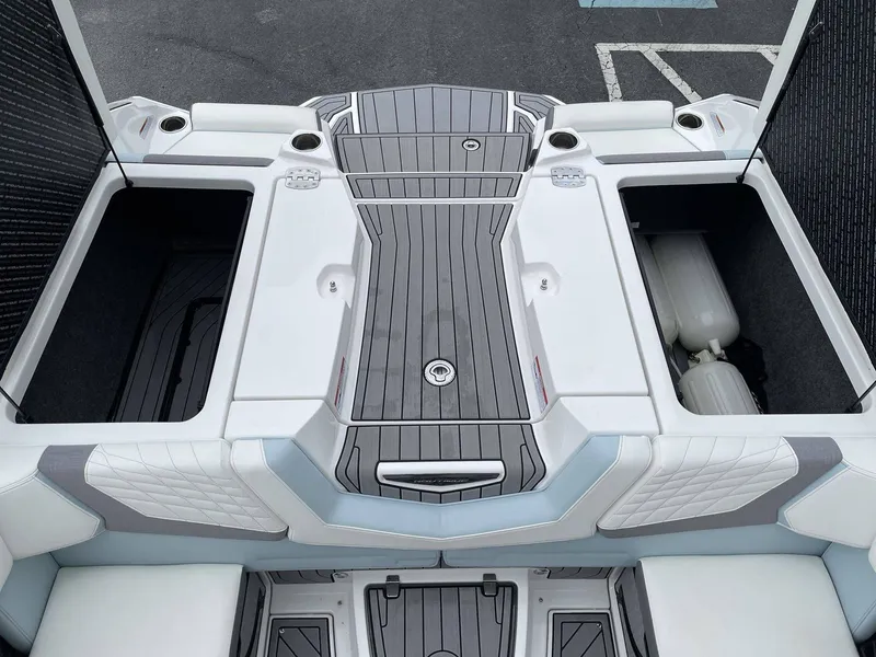 Slide: The Image of Rear view of 2022 Nautique G25 boat with storage compartments. - 27