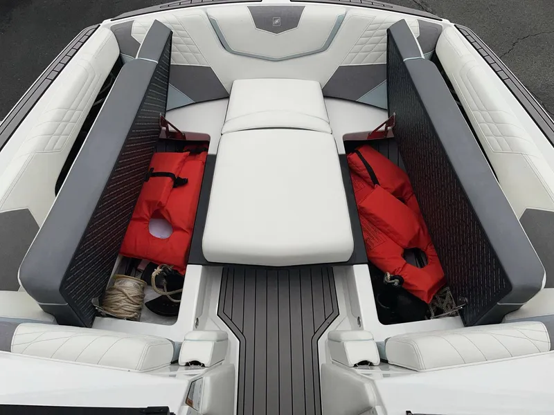 Slide: The Image of Interior of 2022 Nautique G25 with storage and life jackets. - 28