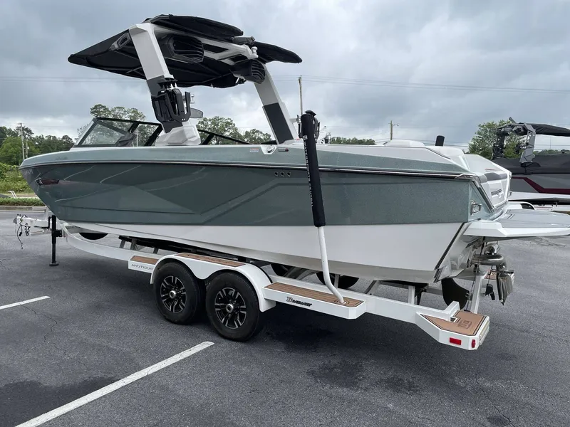 Slide: The Image of 2022 Nautique G25 boat on trailer, side view. - 36