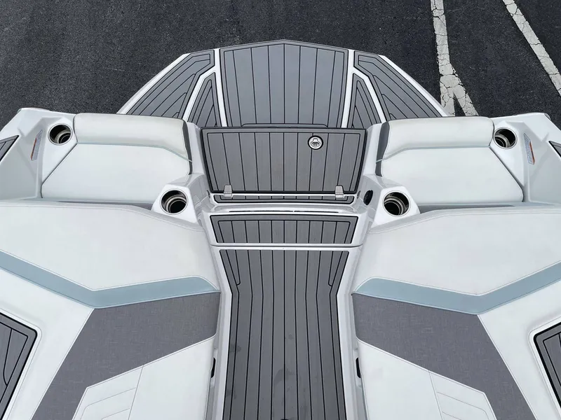 Slide: The Image of Top view of 2022 Nautique G25 boat deck with gray accents. - 8