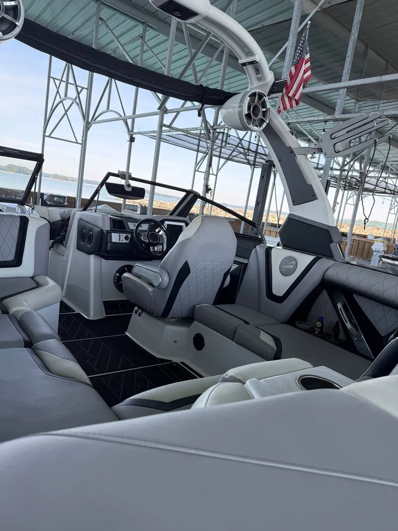 Slide: The Image of Interior of a 2019 Tigé ZX1 boat at the dock. - 5