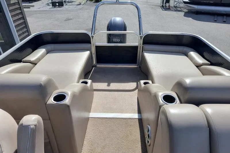 Slide: The Image of 2010 Bennington 2250GCW pontoon boat interior with beige seating and cup holders. - 4