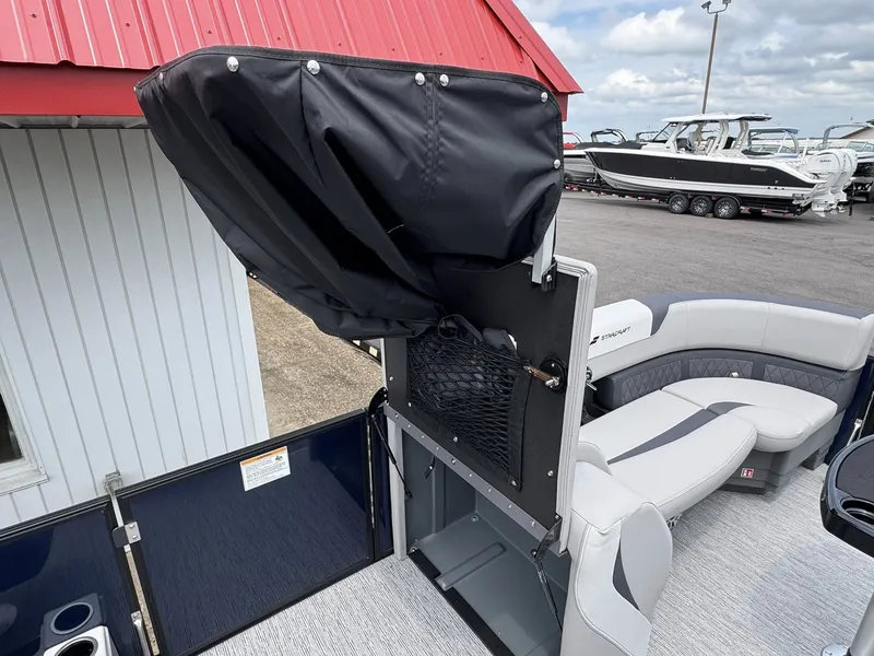 Slide: The Image of Starcraft SLS-5 Q DH 2026 pontoon boat with gray seating and black canopy. - 20