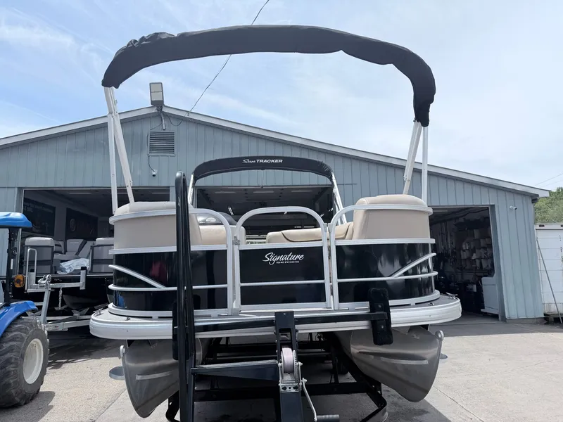 Slide: The Image of 2016 Sun Tracker Party Barge 22 DLX in front of a garage. - 10