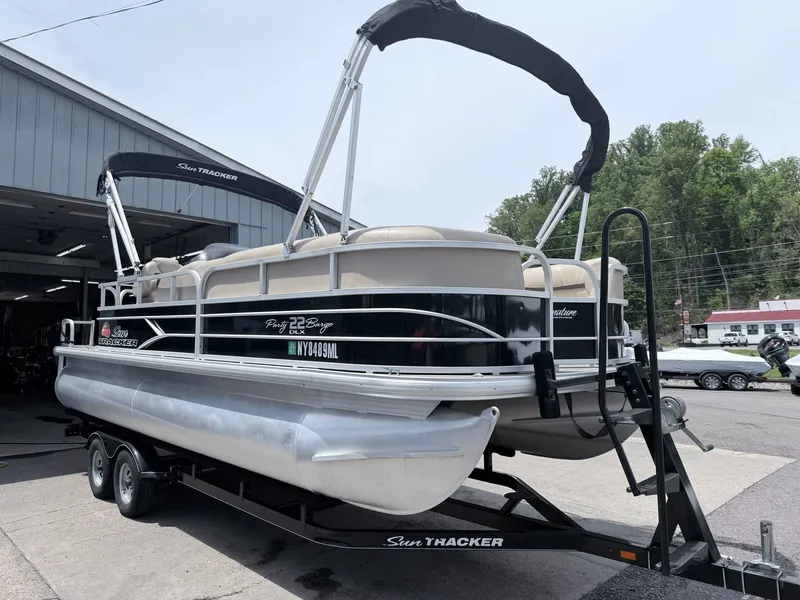 Slide: The Image of 2016 Sun Tracker Party Barge 22 DLX on trailer outside garage. - 16