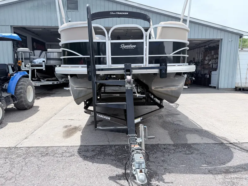 Slide: The Image of 2016 Sun Tracker Party Barge 22 DLX on trailer outside warehouse. - 20