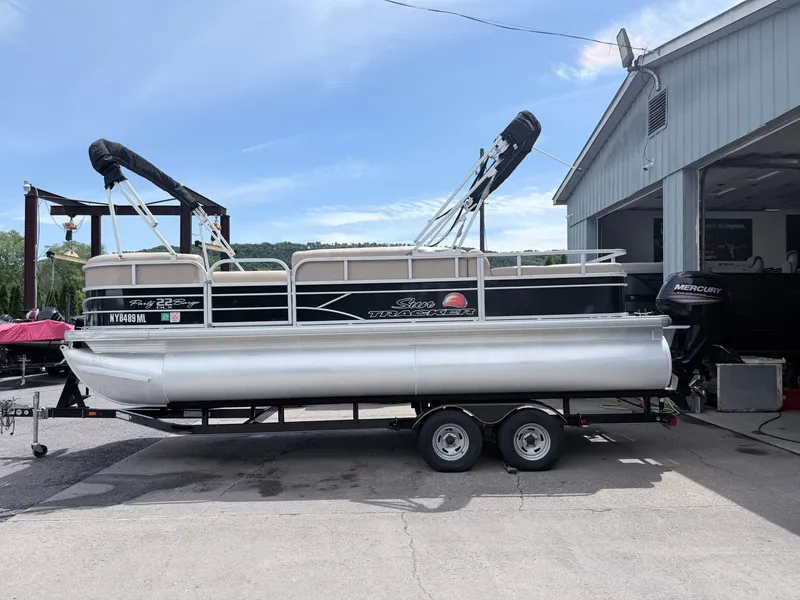 Slide: The Image of 2016 Sun Tracker Party Barge 22 DLX on trailer, side view. - 22
