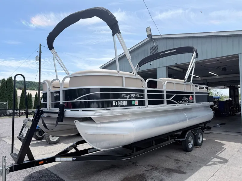 Slide: The Image of 2016 Sun Tracker Party Barge 22 DLX on trailer outside garage. - 28