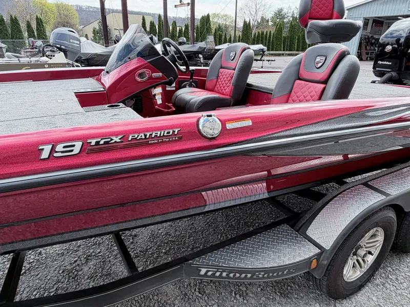 Slide: The Image of Red 2017 Triton 19 TrX Patriot boat on trailer. - 10