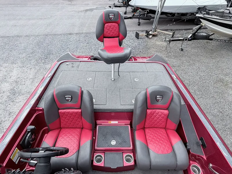 Slide: The Image of Interior of a 2017 Triton 19 TrX boat with red seats. - 11