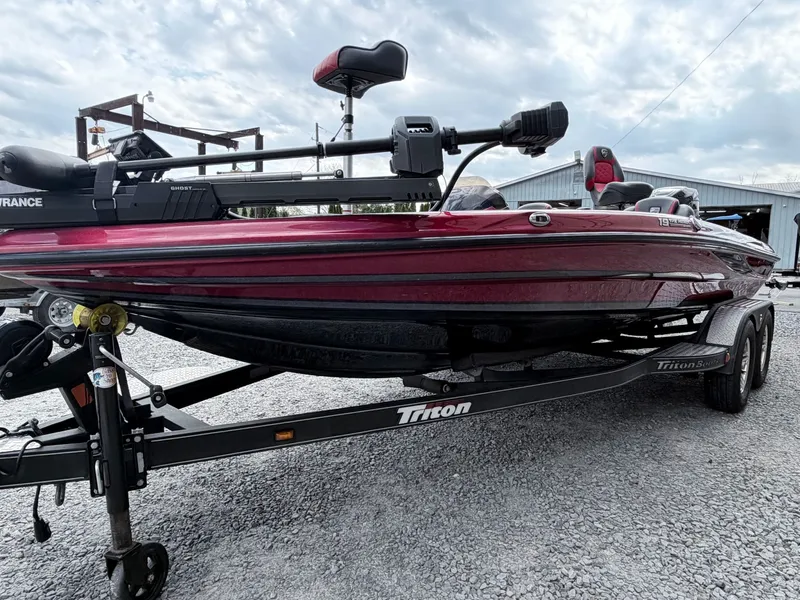 Slide: The Image of 2017 Triton 19 TrX boat on trailer, red color. - 23