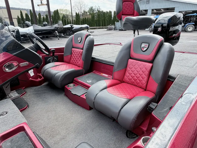 Slide: The Image of Interior of a 2017 Triton 19 TrX with red and gray seats. - 24
