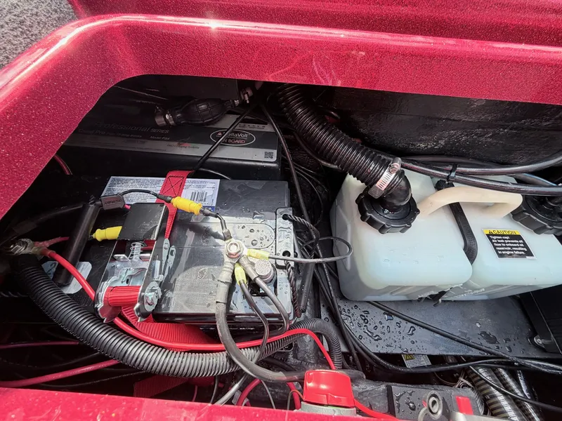 Slide: The Image of Battery compartment of a 2017 Triton 19 TrX boat with wiring. - 39