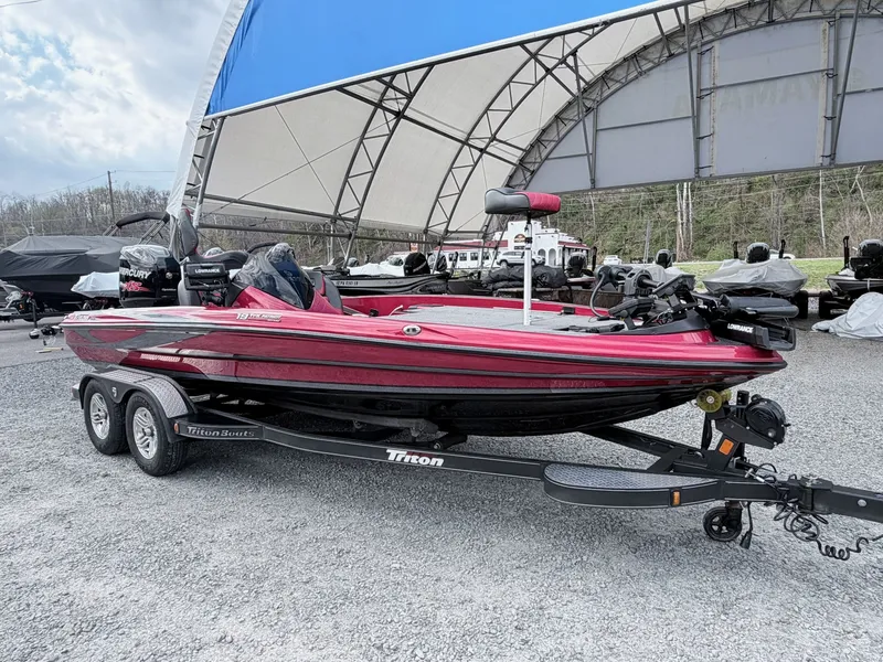 Slide: The Image of Red 2017 Triton 19 TrX boat on trailer outdoors. - 48
