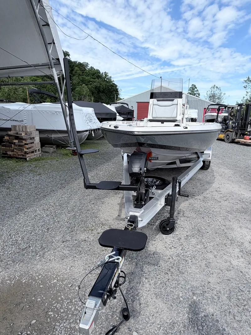Slide: The Image of 2026 Skeeter SX221 boat parked on trailer outdoors. - 11
