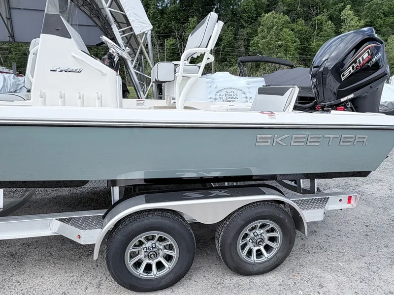 Slide: The Image of 2026 Skeeter SX221 boat on trailer with Yamaha engine. - 13