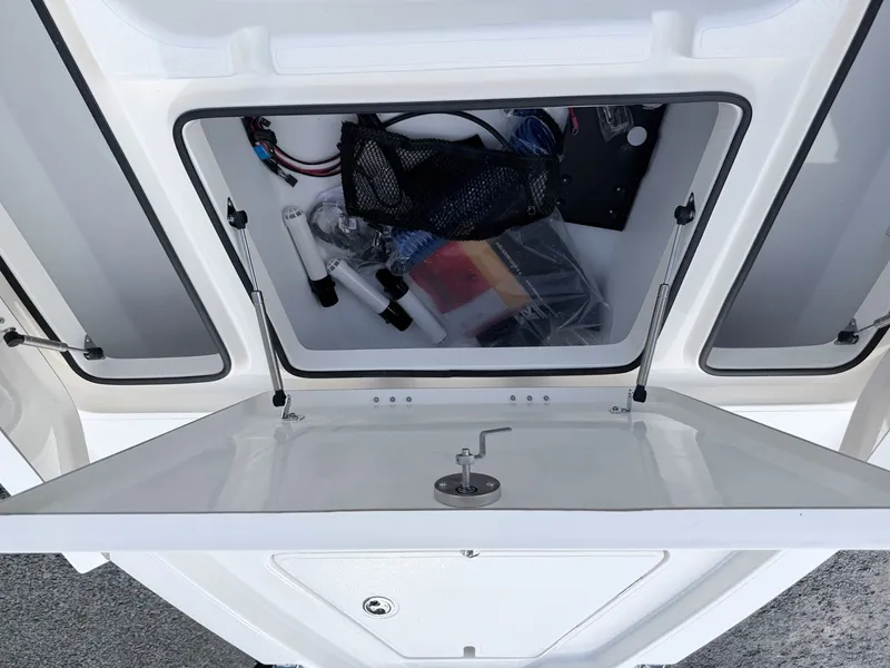 Slide: The Image of Open storage compartment of a 2026 Skeeter SX221 boat. - 19