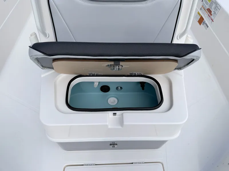 Slide: The Image of Skeeter SX221 2026 boat with open storage compartment lid. - 27