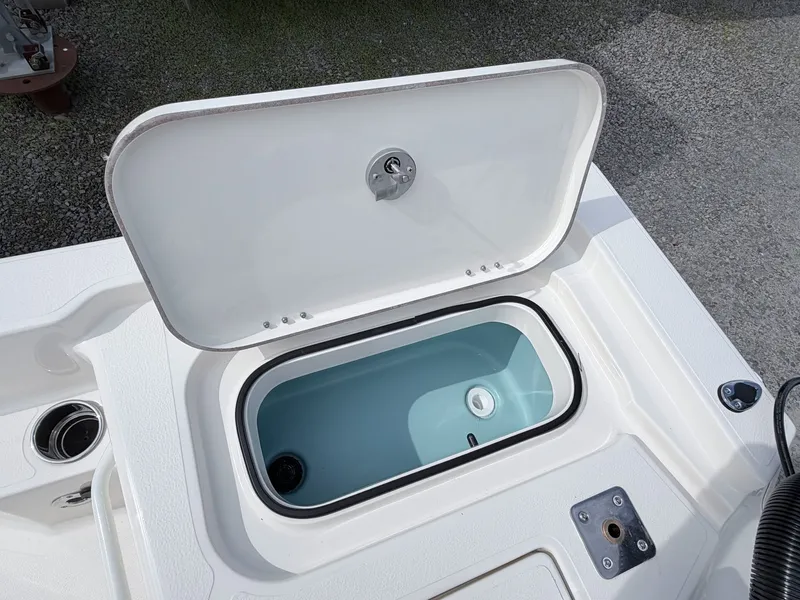 Slide: The Image of Open storage compartment on a 2026 Skeeter SX221 boat. - 29