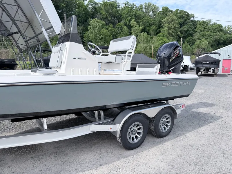 Slide: The Image of 2026 Skeeter SX221 boat parked on trailer outdoors. - 3