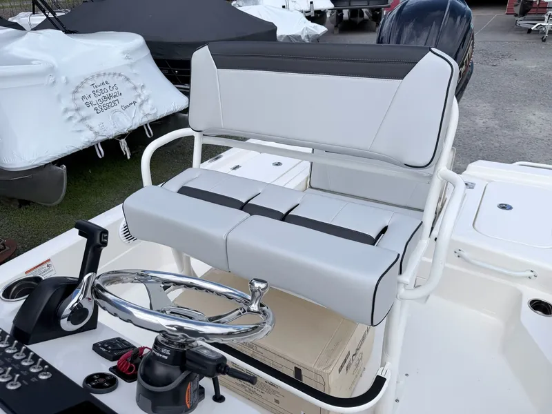 Slide: The Image of Skeeter SX221 2026 boat console with steering wheel and bench seat. - 30
