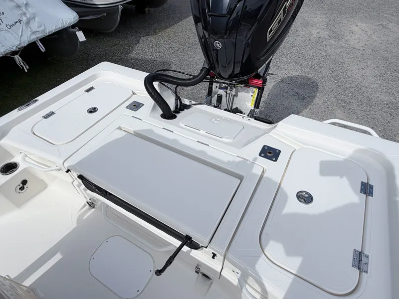 Slide: The Image of Skeeter SX221 2026 boat rear with motor and storage compartments. - 33