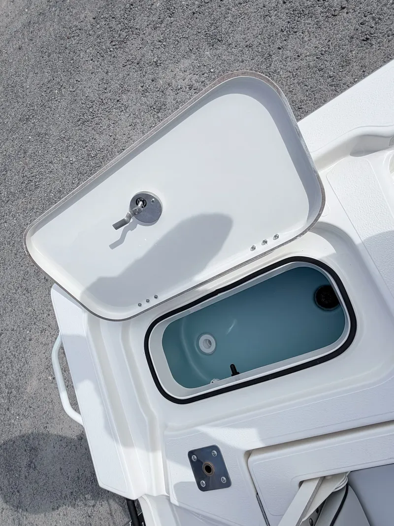 Slide: The Image of Open storage compartment on 2026 Skeeter SX221 boat. - 41