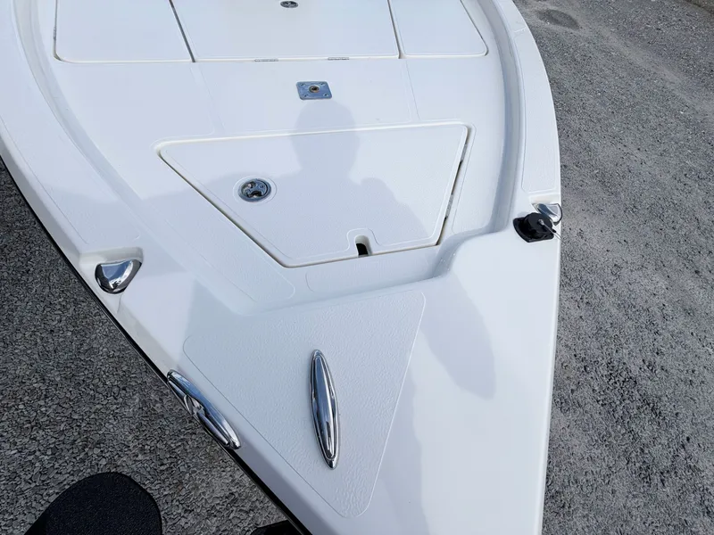 Slide: The Image of Bow of a 2026 Skeeter SX221 boat on gravel. - 48
