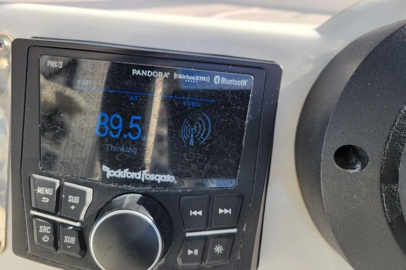 Slide: The Image of Close-up of Rockford Fosgate stereo on 2022 Highfield Sport 460 boat, displaying FM 89.5. - 12