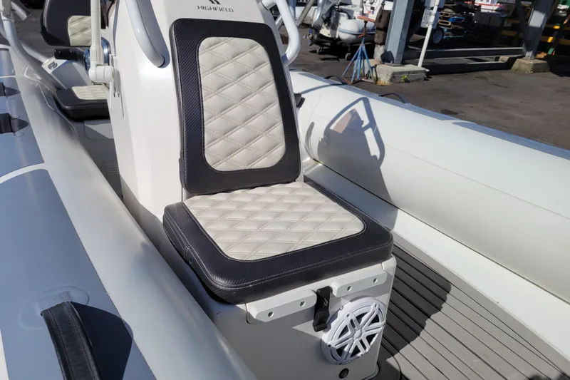 Slide: The Image of 2022 Highfield Sport 460 boat seat with diamond-pattern upholstery and speaker. - 17