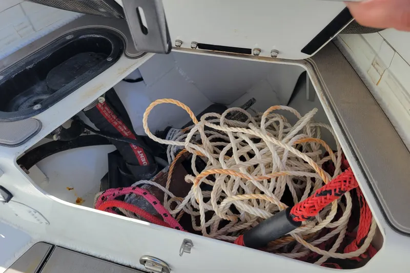 Slide: The Image of Open storage compartment on 2022 Highfield Sport 460 boat with ropes and equipment. - 19