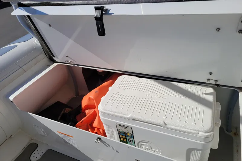 Slide: The Image of Open storage compartment on 2022 Highfield Sport 460 boat with cooler and life jackets. - 20