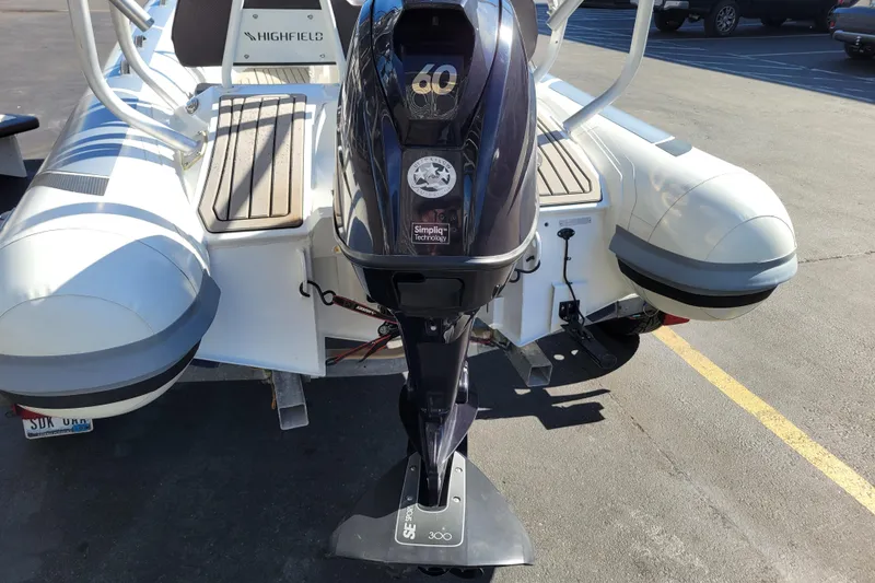 Slide: The Image of Highfield Sport 460 boat, 2022 model, featuring a powerful outboard motor in a parking lot. - 21