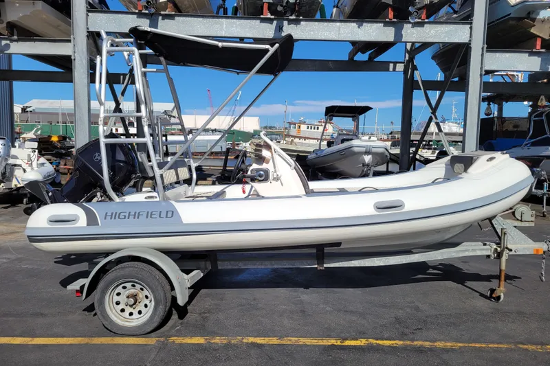 Slide: The Image of 2022 Highfield Sport 460 boat on trailer in marina setting. - 5