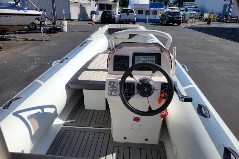 Slide: The Image of 2022 Highfield Sport 460 boat interior with steering wheel and dashboard controls. - 7