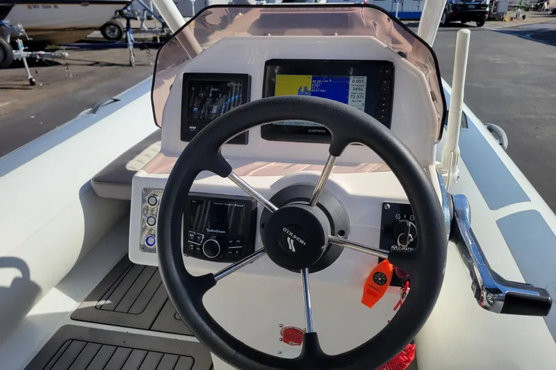 Slide: The Image of Steering console of 2022 Highfield Sport 460 boat with navigation equipment and controls. - 9