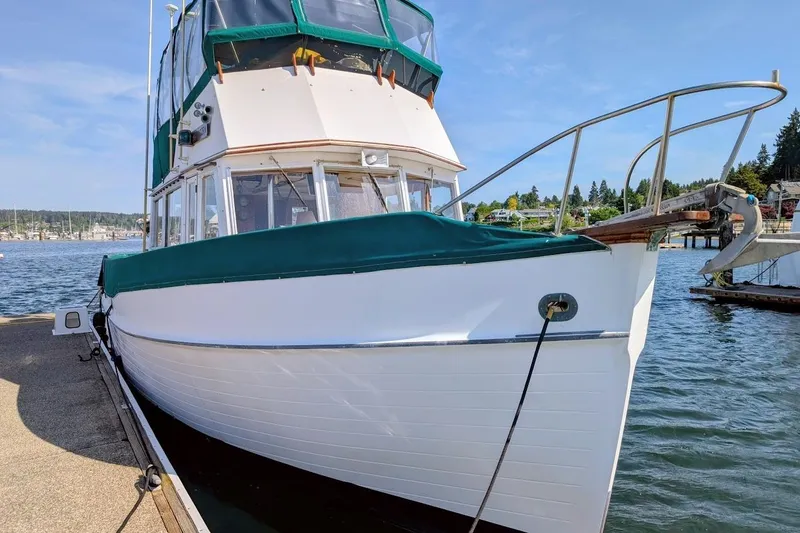 Slide: The Image of 1979 Grand Banks 42 Classic yacht docked by the water on a sunny day. - 1