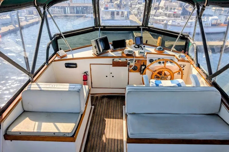 Slide: The Image of 1979 Grand Banks 42 Classic yacht helm with wooden wheel and navigation equipment. - 12